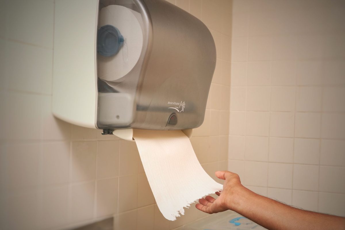 A,Man,Getting,Issue,Paper,From,An,Automatic,Wall,Mounted